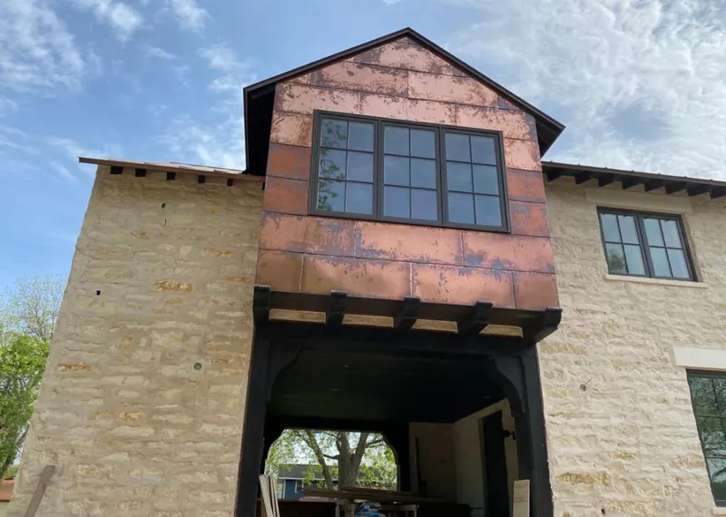 Copper metal panel facade on a stone building for Metal Roof Coating in Jasmine Estates